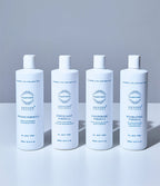 Four white bottles side by side labelled Oxygen Formula, Exfoliant Formula, Couperose Formula and Hydrating Formula, each 500ml 16.9 fl.oz