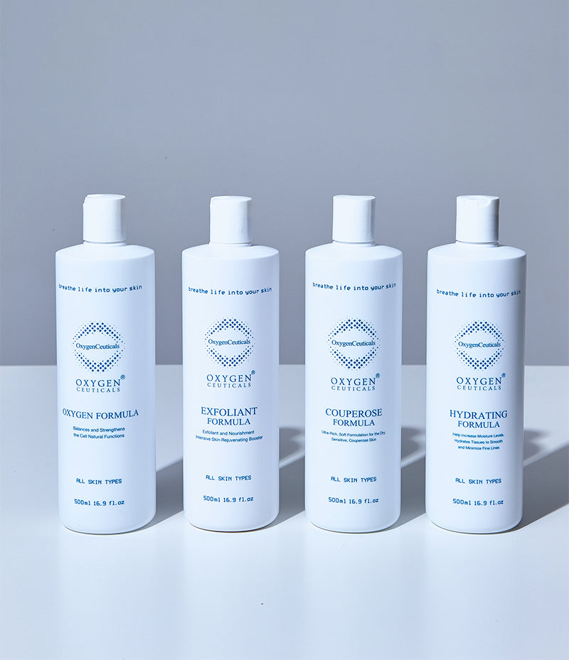 Four white bottles side by side labelled Oxygen Formula, Exfoliant Formula, Couperose Formula and Hydrating Formula, each 500ml 16.9 fl.oz